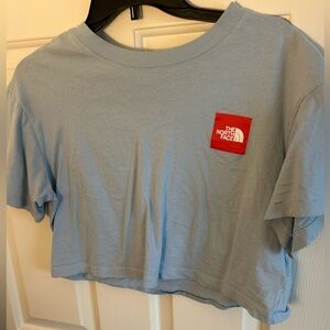 A light blue The North Face crop top
